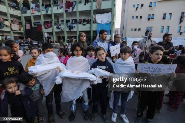 Palestinian children march during a protest demanding an end to the war and their right to live, education and play on February 14, 2024 in Rafah,...