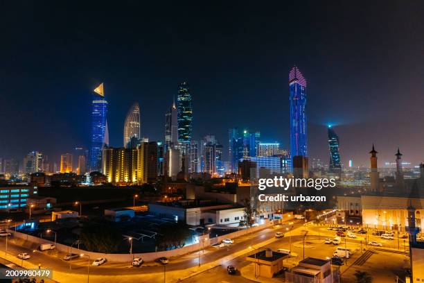 panoramic view of kuwait city skyline at night - kuwait landmark stock pictures, royalty-free photos & images