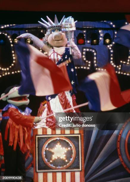 Jim Henson's Muppets visit London during The Muppet Show on Tour in 1987. Muppets carry flags on stage around Miss Piggy, who is dressed in red,...