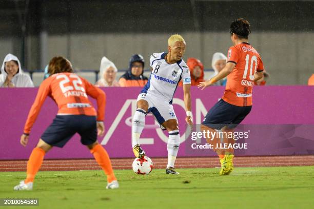 Yosuke Ideguchi of Gamba Osaka takes on Genki Omae of Omiya Ardija during the J.League J1 match between Omiya Ardija and Gamba Osaka at Kumagaya...