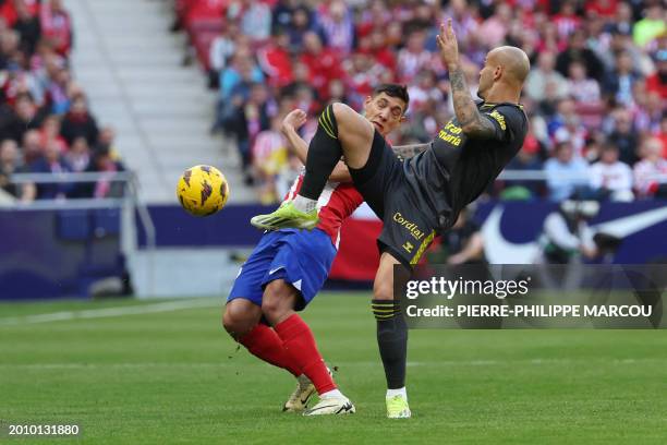 Atletico Madrid's Argentine defender Nahuel Molina fights for the ball with Las Palmas' Spanish forward Sandro Ramirez during the Spanish league...