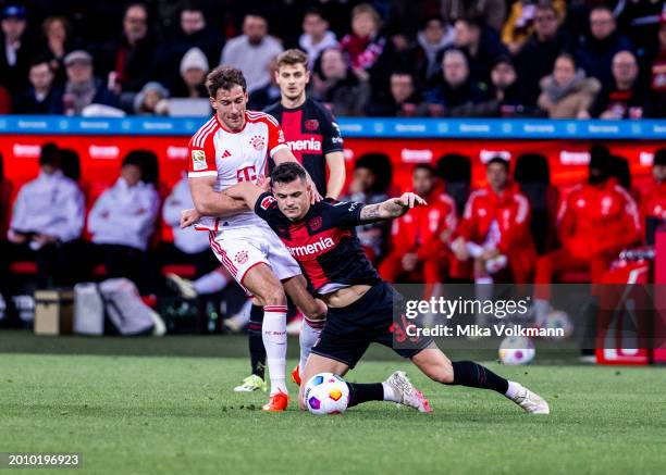 Leon Goretzka of Muenchen challenges Granit Xhaka of Leverkusen during the Bundesliga match between Bayer 04 Leverkusen and FC Bayern Muenchen at...