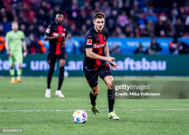Josip Stanisic of Leverkusen runs with the ball during the Bundesliga match between Bayer 04 Leverkusen and FC Bayern Muenchen at BayArena on...