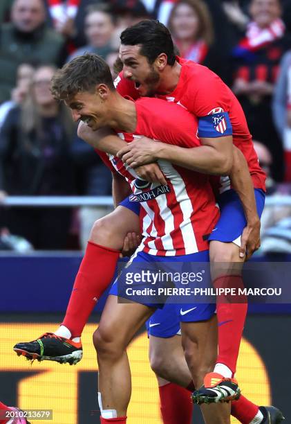Atletico Madrid's Spanish midfielder Marcos Llorente celebrates scoring the second goal, with Atletico Madrid's Spanish midfielder Koke, during the...