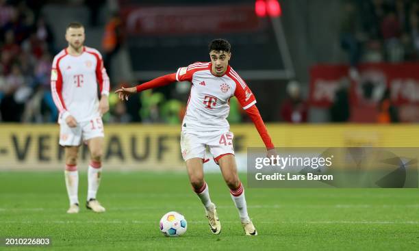 Aleksandar Pavlovic of Bayern Munich runs with the ball during the Bundesliga match between Bayer 04 Leverkusen and FC Bayern München at BayArena on...