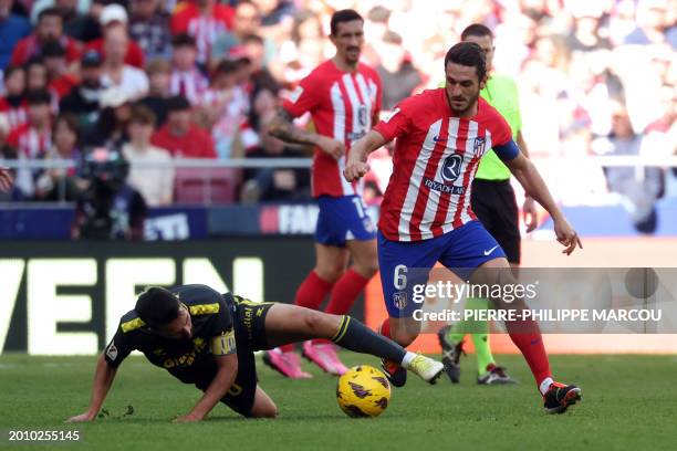 Las Palmas' Spanish midfielder Kirian Rodriguez fights for the ball with Atletico Madrid's Spanish midfielder Koke during the Spanish league football...