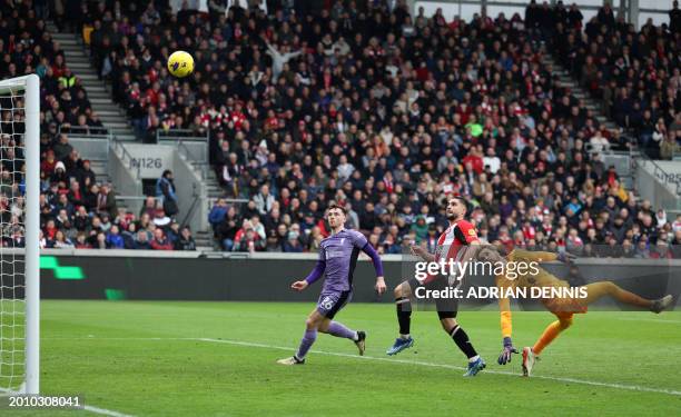 Brentford's French striker Neal Maupay attempts to beat Liverpool's Irish goalkeeper Caoimhin Kelleher but was flagged offside during the English...