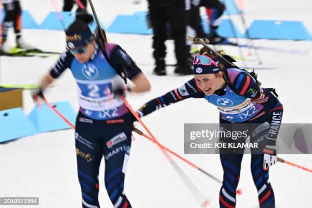 France's Justine Braisaz-Bouchet hands over to France's Julia Simon during the women's 4x6km relay event of the IBU Biathlon World Championships in...