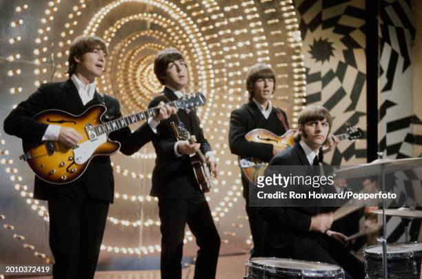 English rock and pop group The Beatles perform on the set of a pop music television show in London on 16th June 1966. Members of the band are, from...