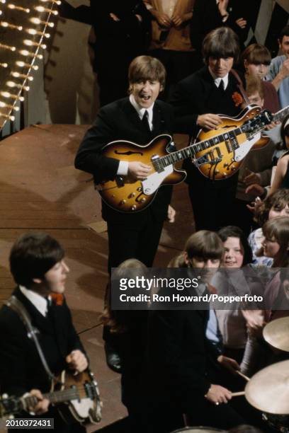 View from above of English rock and pop group The Beatles performing in front of a studio audience on the set of a pop music television show in...