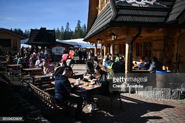 People enjoy the sun outdoors during an unusually high-temperature day in Zakopane, Poland on February 16, 2024. Poland is now having unusually warm...