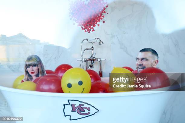 Store window displays cardboard cutouts of Travis Kelce and Taylor Swift during the Kansas City Chiefs Super Bowl LVIII victory parade on February...