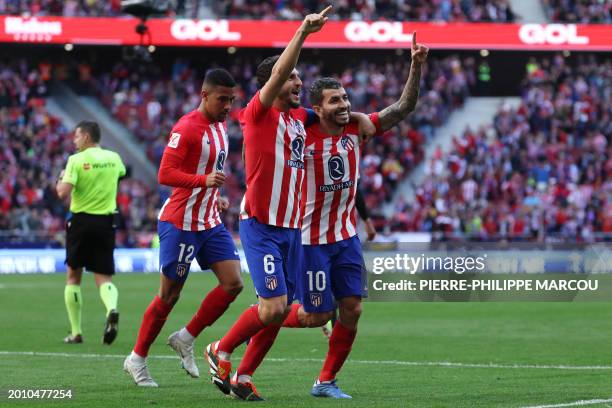 Atletico Madrid's Argentinian forward Angel Correa celebrates scoring his team's fourth goal, with Atletico Madrid's Spanish midfielder Koke, during...