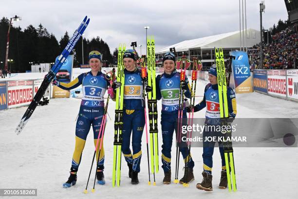 Sweden's Elvira Oberg, Sweden's Hanna Oberg, Sweden's Linn Persson and Sweden's Anna Magnusson celebrate after taking the second place in the women's...