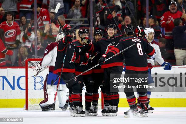 Martin Necas of the Carolina Hurricanes celebrates with his team following his hat trick goal during the first period of the game against the...