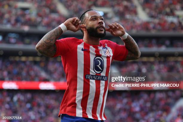 Atletico Madrid's Dutch forward Memphis Depay celebrates scoring his team's fifth goal during the Spanish league football match between Club Atletico...