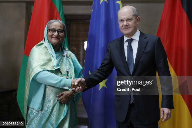 German Chancellor Olaf Scholz and Prime Minister of Bangladesh Sheikh Hasina Wajed shake hands as they pose for the media during bilateral talks at...
