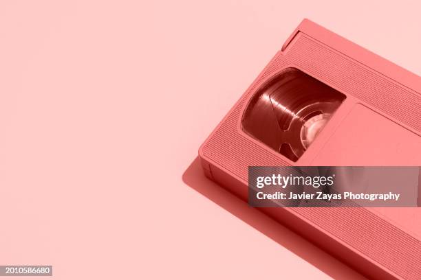 vhs videocassette on peach background - retro television stock pictures, royalty-free photos & images