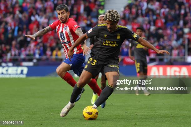 Atletico Madrid's Argentinian forward Angel Correa vies for the ball with Las Palmas' Equatorial Guinean-Spanish defender Saul Coco during the...