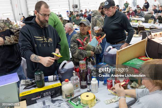 People check in at a Coyote hunt fundraising meal to end three days of coyote hunting after the last Coyote hunt contest on February 4 in White...