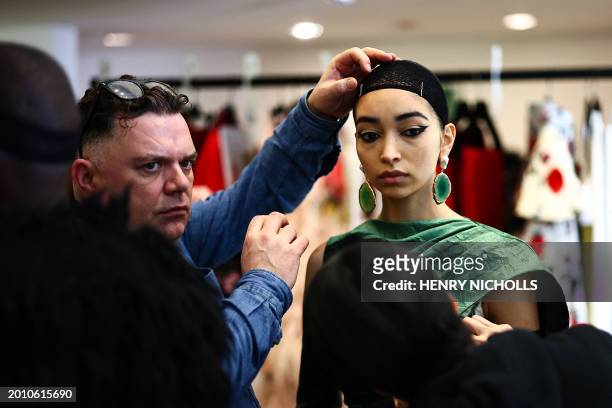 Models are prepared back-stage ahead of a catwalk presentation by Erdem for their Autumn/Winter 2024 collection during London Fashion Week in London...