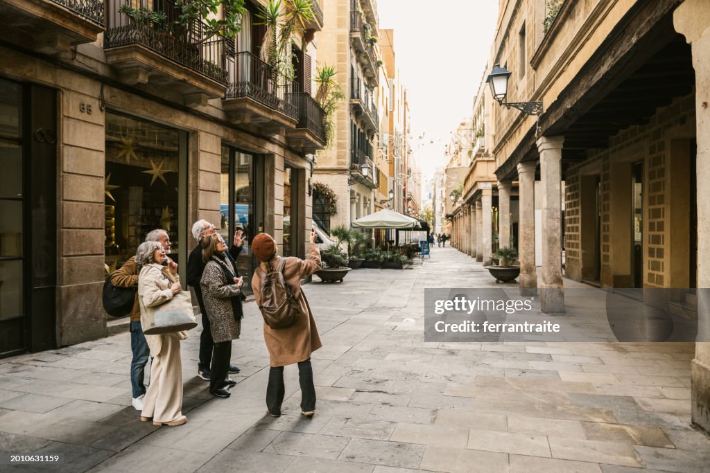 Tourist guide showing the city to group of seniors