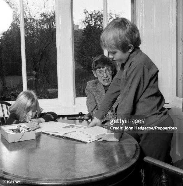 English theoretical physicist Stephen Hawking at home with his son Robert and daughter Lucy in Cambridge, England in 1978. Hawking, currently a...