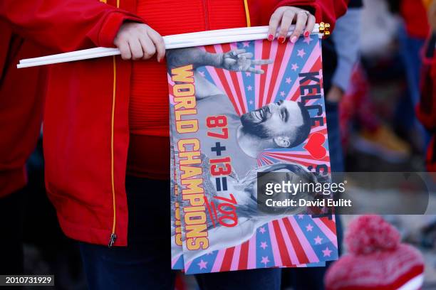 Fan holds up a flag of Travis Kelce of the Kansas City Chiefs and Taylor Swift during the Kansas City Chiefs Super Bowl LVIII victory parade on...