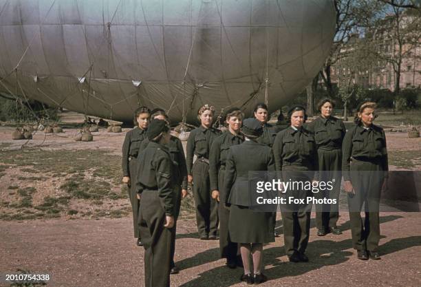 Women's Auxiliary Air Force personnel during an inspection, on a barrage balloon site during World War Two, in the Temple area of the City of London,...