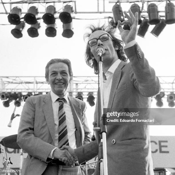 Italian actor Roberto Benigni jokes with the general secretary of the Italian Communist Party Enrico Berlinguer during an electoral rally at the...