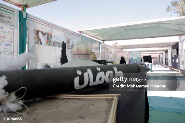 People walk near mock models of missiles displayed in solidarity with Palestinians and against the Israeli sustained bombardment on the Gaza Strip on...