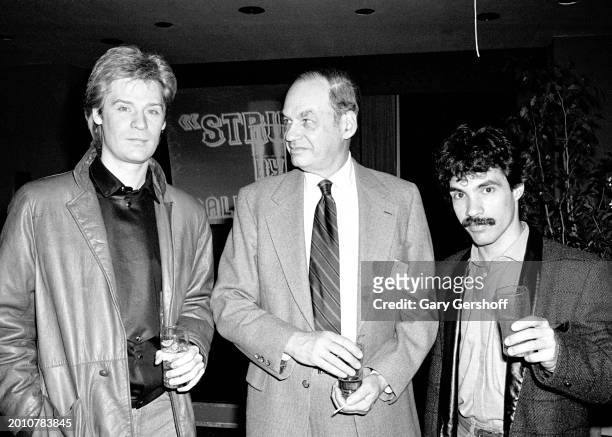 American broadcast journalist Edwin Newman poses with Pop musicians Daryl Hall and John Oates, of the duo Hall & Oates, as they attend WNBC's Source...