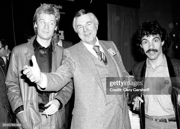 American radio & TV announcer Don Pardo poses with Pop musicians Daryl Hall and John Oates, of the duo Hall & Oates, as they attend WNBC's Source...
