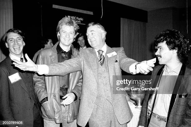 American radio & TV announcer Don Pardo poses with Pop musicians Daryl Hall and John Oates, of the duo Hall & Oates, as they attend WNBC's Source...