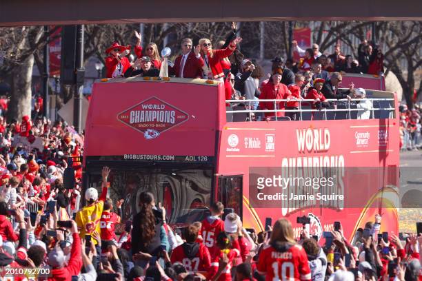 Head coach Andy Reid and owner Clark Hunt of the Kansas City Chiefs wave to fans during the Kansas City Chiefs Super Bowl LVIII victory parade on...