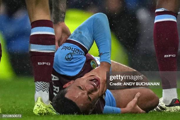 Burnley's English midfielder Aaron Ramsey reacts after picking up an injury during the English Premier League football match between Burnley and...