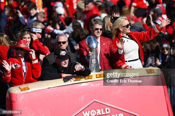 Head coach Andy Reid and owner Clark Hunt of the Kansas City Chiefs wave to fans during the Kansas City Chiefs Super Bowl LVIII victory parade on...