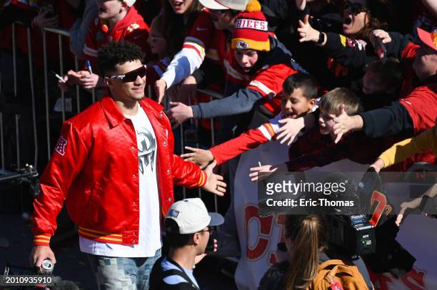 Patrick Mahomes of the Kansas City Chiefs celebrates with fans during the Kansas City Chiefs Super Bowl LVIII victory parade on February 14, 2024 in...