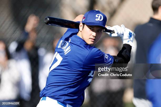 Shohei Ohtani of the Los Angeles Dodgers swings the bat during workouts at Camelback Ranch on February 14, 2024 in Glendale, Arizona.