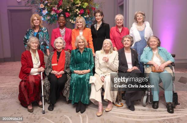 Queen Camilla smiles as she poses with Dames Joanna Lumley, Floella Benjamin, Twiggy Lawson, Harriet Walter, Penelope Wilton, Maureen Lipman Virginia...