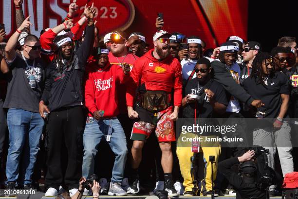 Travis Kelce of the Kansas City Chiefs celebrates on stage with teammates during the Kansas City Chiefs Super Bowl LVIII victory parade on February...