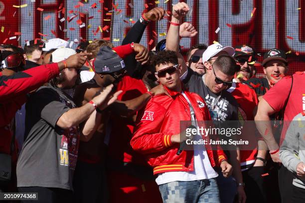 Patrick Mahomes of the Kansas City Chiefs celebrates with teammates on stage during the Kansas City Chiefs Super Bowl LVIII victory parade on...