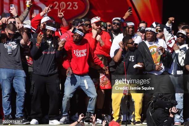 Travis Kelce of the Kansas City Chiefs celebrates with teammates on stage during the Kansas City Chiefs Super Bowl LVIII victory parade on February...