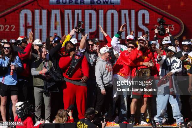 Travis Kelce of the Kansas City Chiefs addresses the fans on stage during the Kansas City Chiefs Super Bowl LVIII victory parade on February 14, 2024...