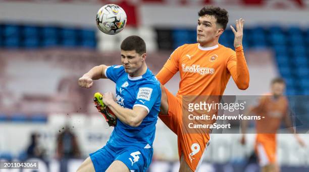 Blackpool's Kyle Joseph competing with Peterborough United's Ronnie Edwards during the Sky Bet League One match between Peterborough United and...