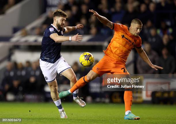 Harry Clarke of Ipswich Town is challenged by Tom Bradshaw of Millwall during the Sky Bet Championship match between Millwall and Ipswich Town at The...