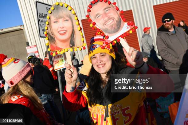 Fan holds up a sign of Taylor Swift and Travis Kelce of the Kansas City Chiefs during the Kansas City Chiefs Super Bowl LVIII victory parade on...
