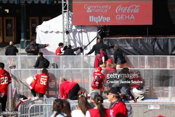 People take cover during a shooting at Union Station during the Kansas City Chiefs Super Bowl LVIII victory parade on February 14, 2024 in Kansas...