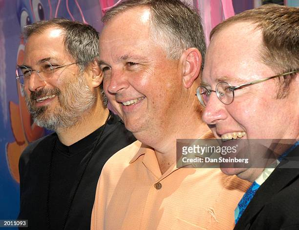 Of Apple Steve Jacobs, Disney Executive Dick Cook and Producer John Lasseter arrive at the premiere of "Finding Nemo" at the El Capitan theatre on...