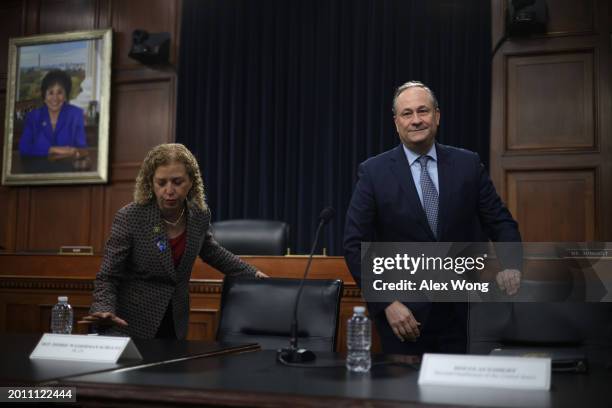 Rep. Debbie Wasserman Schultz and Doug Emhoff , husband of Vice President Kamala Harris, take their seats during a roundtable discussion at Rayburn...